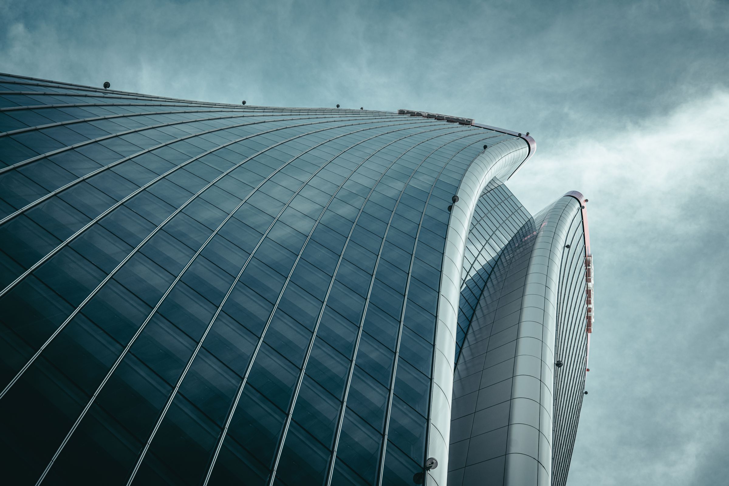 Curved glass tower against the sky